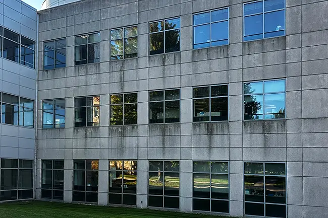A grimy and stained commercial building exterior before a professional commercial building washing service in service in Appleton, Wisconsin.