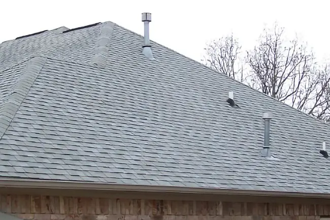 The same residential asphalt shingle roof looking completely clean and restored after a professional roof soft wash service service in Neenah, Wisconsin.